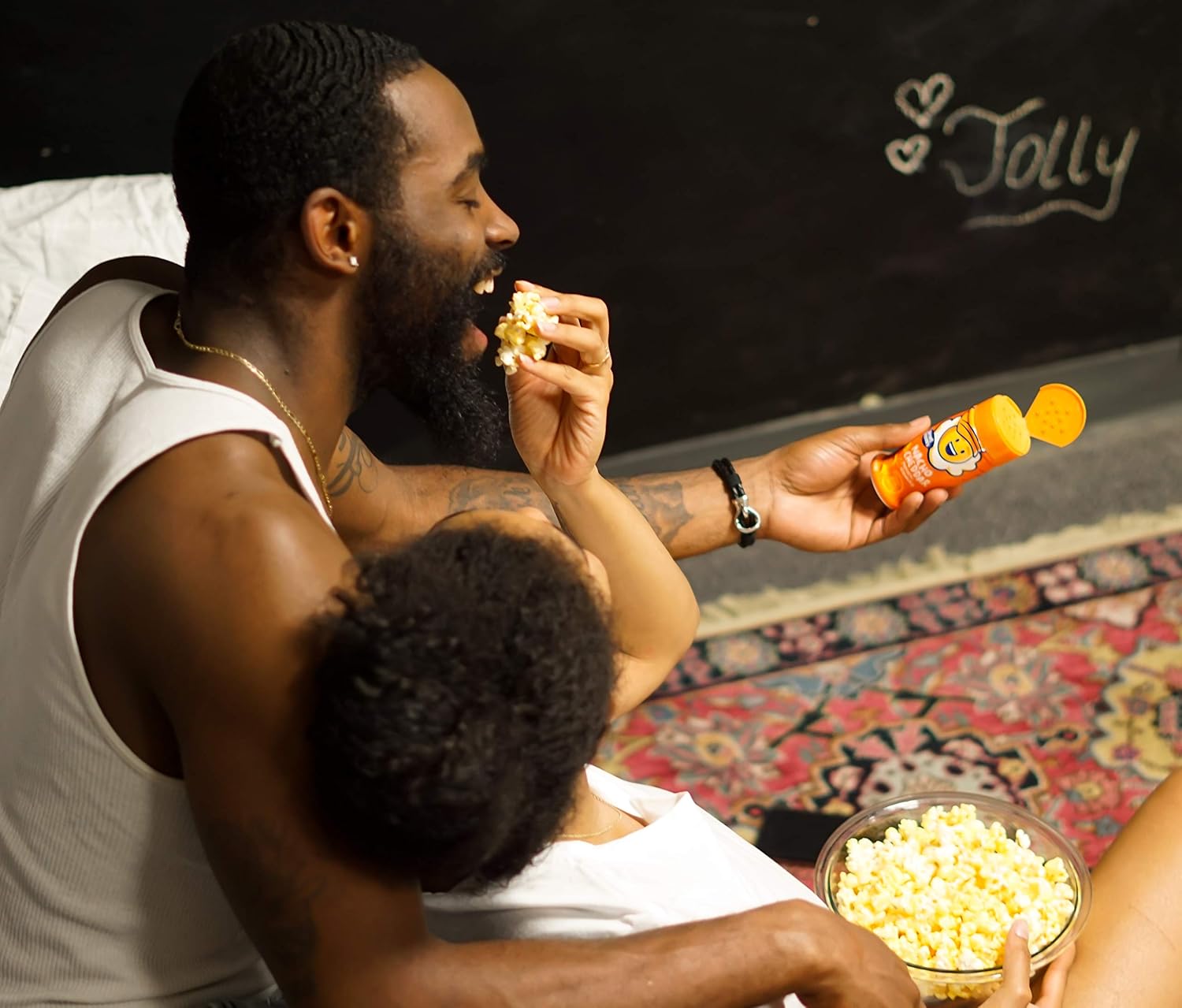 Family enjoying Kernel Season's nacho cheddar popcorn seasoning on popcorn