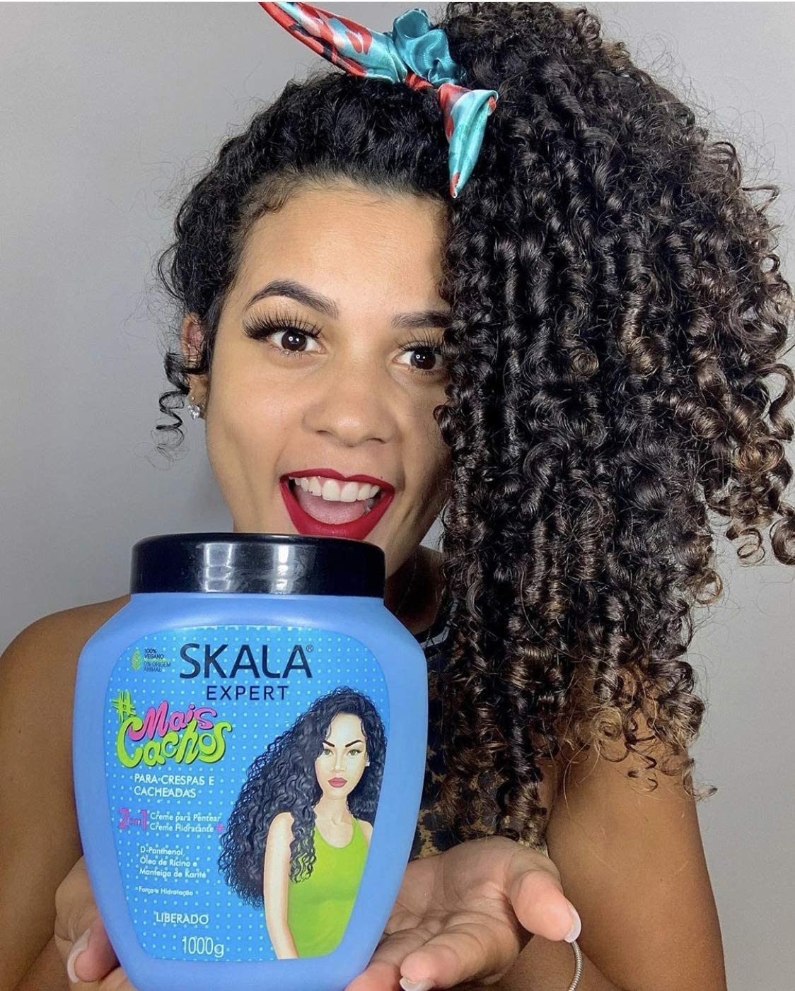 Person holding a Skala expert Corn Cachos cream care product bottle 